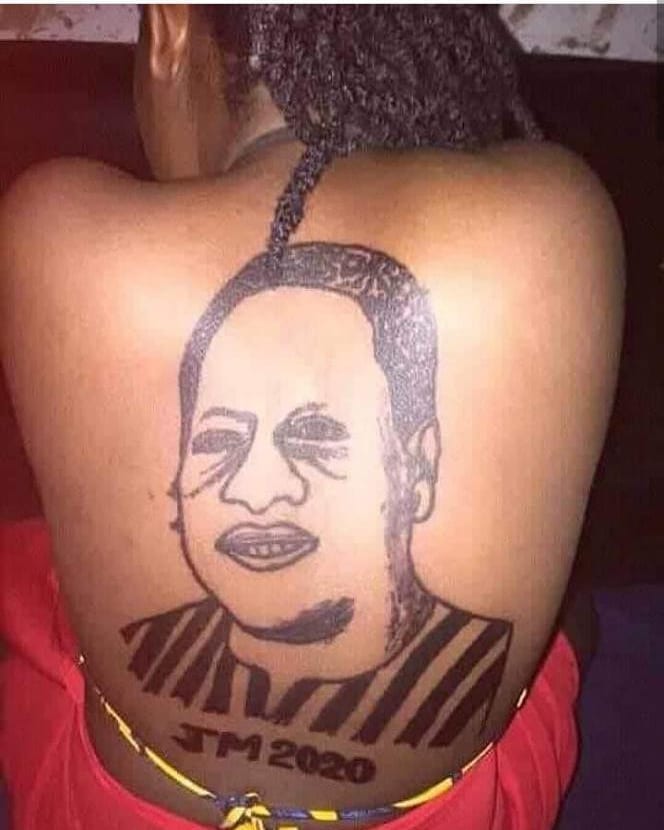 Ghanaian Woman Tattoo face of JM at her back
